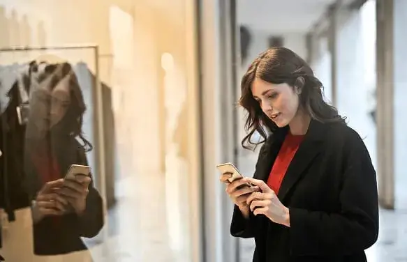 Woman searching online store on mobile phone